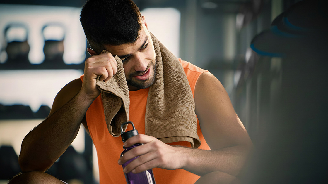 man-wiping-sweat-gym-16-9-1120x630px