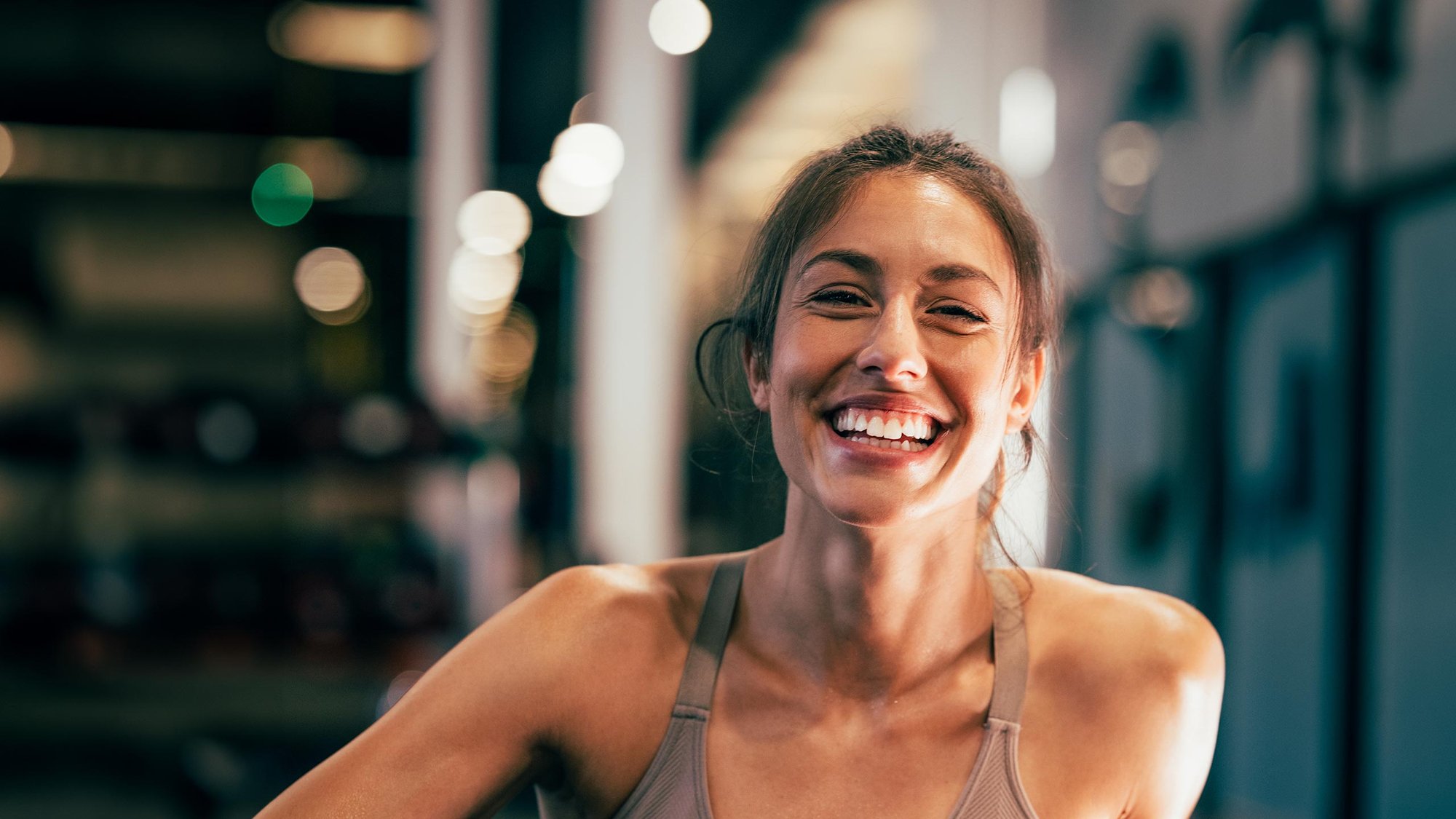 woman-smiling-gym-floor-hero-16-9-2560x1440px