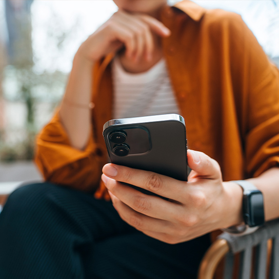 woman-orange-blouse-closeup-phone-1-1-544x544px